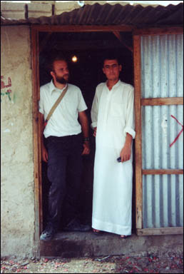 Peace Corps Volunteer Lee Wilbur and a villager at the door of his cola/smokes/soap shop.  Near El-Greyat, Beni-Hamida Mountains, Jordan.