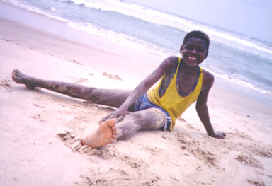 Accra, Ghana, 1994. From the dry northern regions to rainforests and beaches, Ghana is a country of contrasts. Here a boy enjoys the beach. Photo by Peace Corps Volunteer Wayne Breslyn.